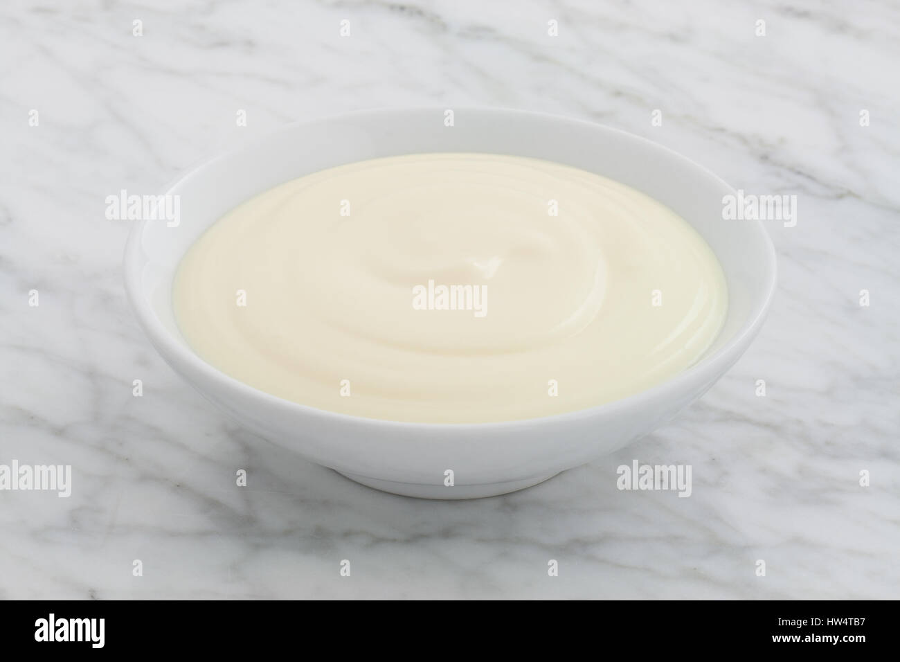 styled greek yogurt on carrara marble countertop Stock Photo