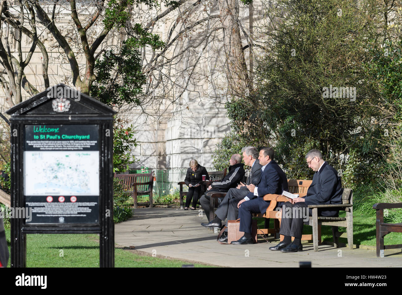 Relaxing in the churchyard gardens at St Paul's Cathedral, London. Stock Photo