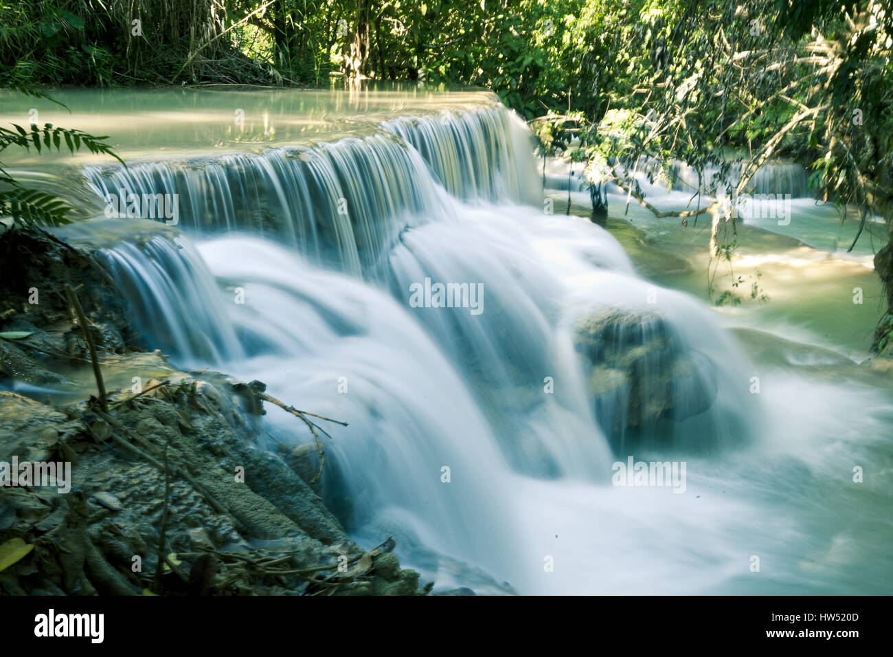 The spectacular Kuang Si Falls also known as Tat Kuang Si Waterfalls is a popular tourist destination in Luang Prabang, Laos. Stock Photo