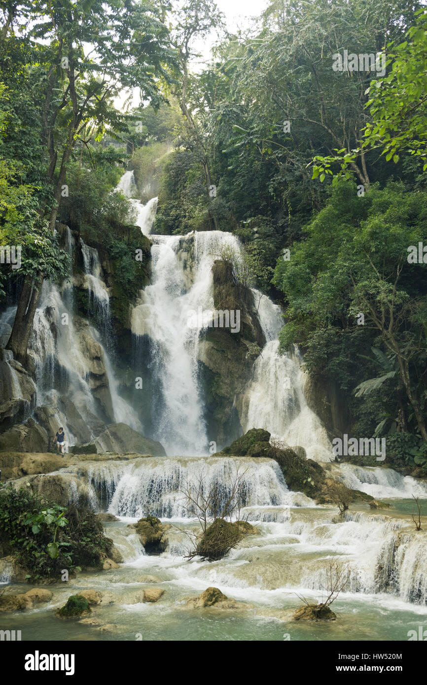 The spectacular Kuang Si Falls also known as Tat Kuang Si Waterfalls is a popular tourist destination in Luang Prabang, Laos. Stock Photo