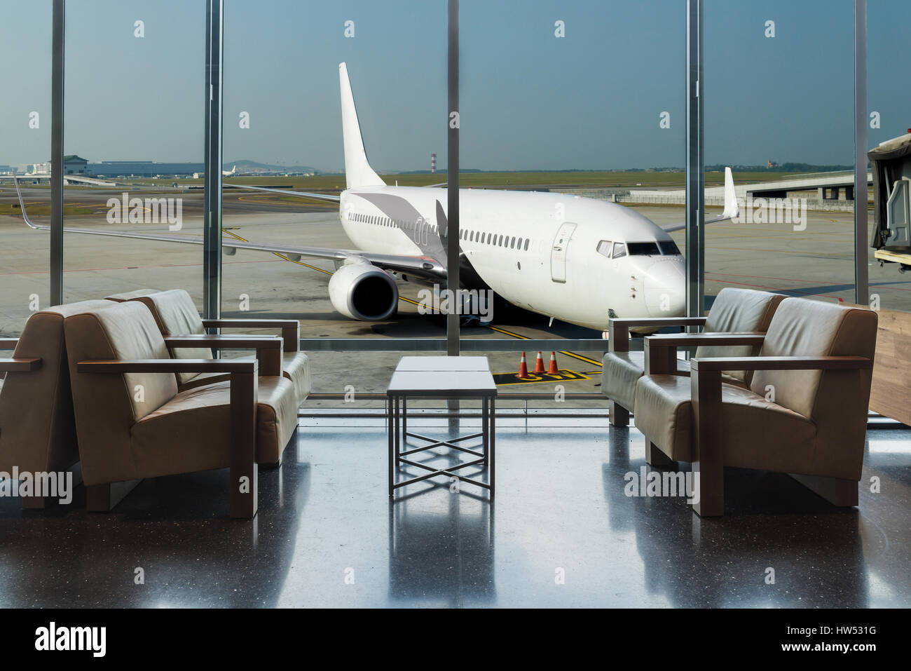 Airplane view from airport lounge in airport terminal. Stock Photo