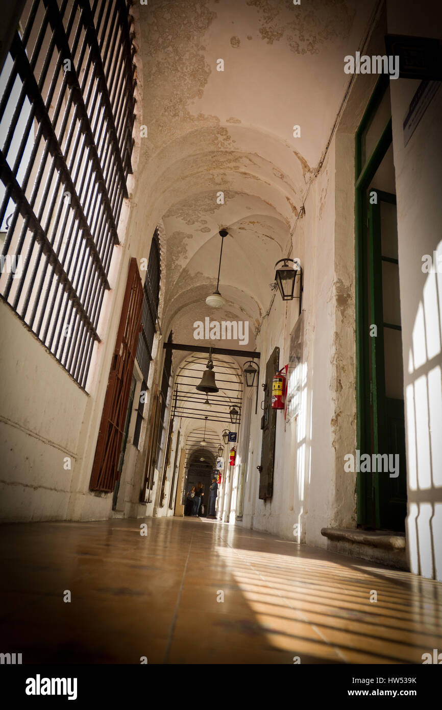 Low angle view of a corridor with vaulted ceiling and heavy bars on the windows in a historic building Stock Photo