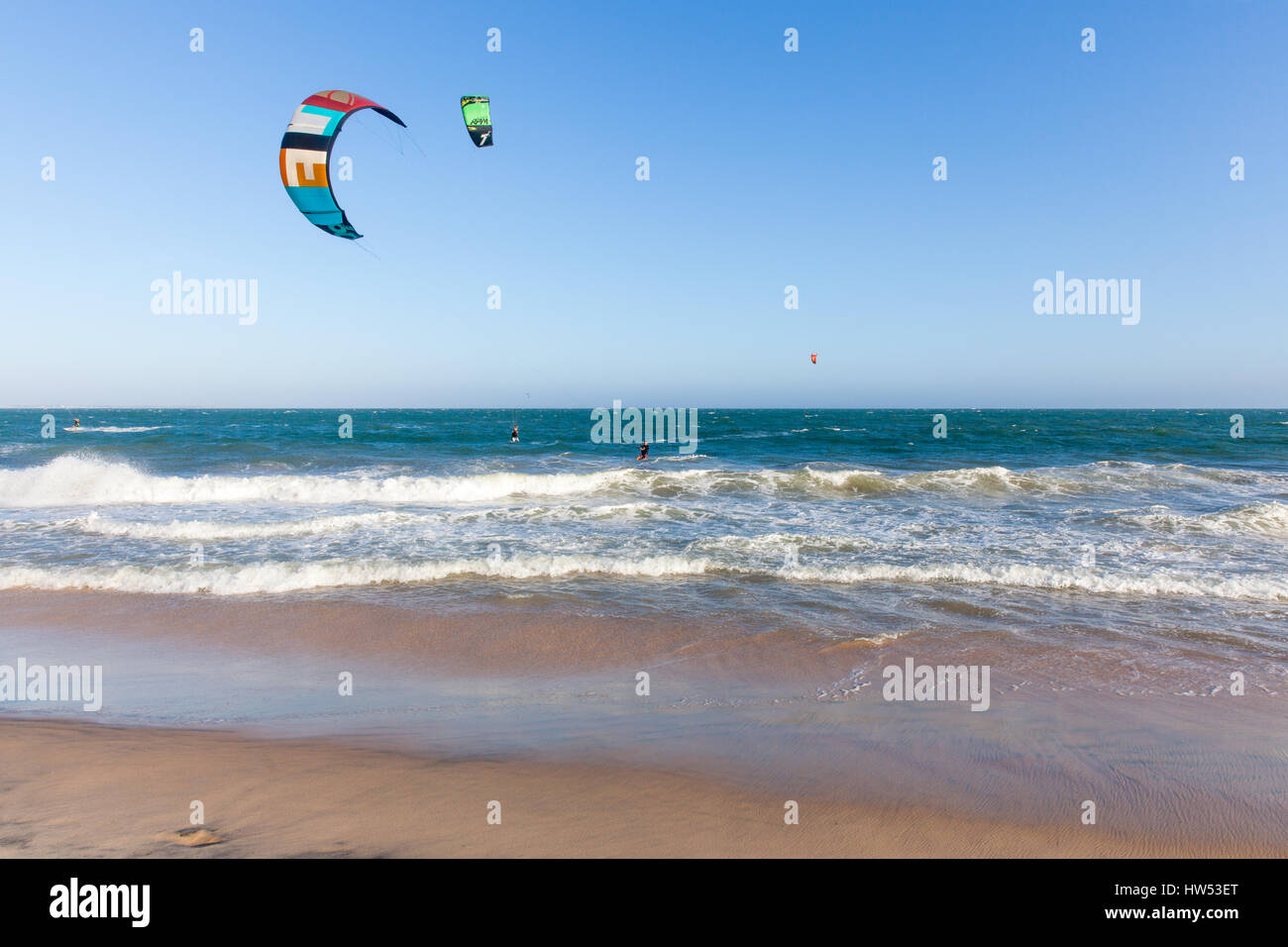 Mui Ne, Vietnam - 24 March, 2014: Kiters ride on the waves at Mui Ne beach, Southern Vietnam on 24 March, 2014. Stock Photo