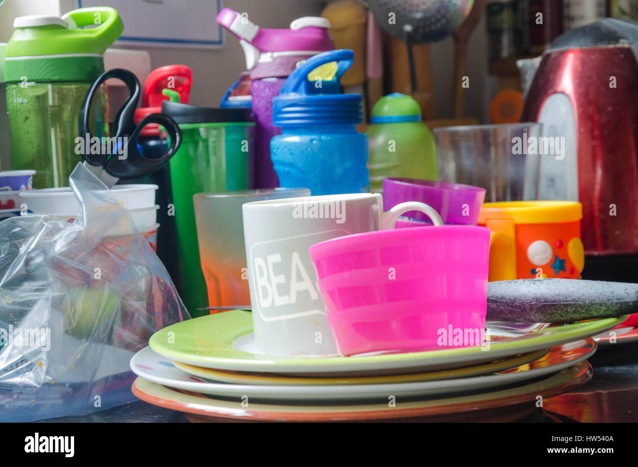 Washing up stacked at the side of a kitchen sink Stock Photo Alamy