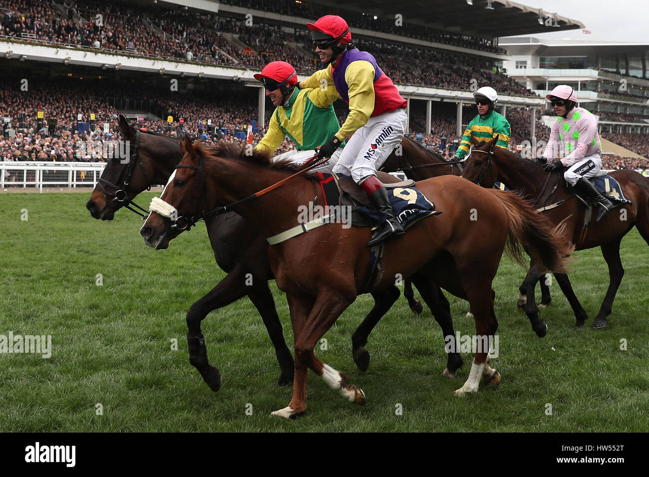 Jockey Robbie Power (left) celebrates after his winning ride on Sizing John in the Timico Cheltenham Gold Cup Chase during Gold Cup Day of the 2017 Cheltenham Festival at Cheltenham Racecourse. Stock Photo