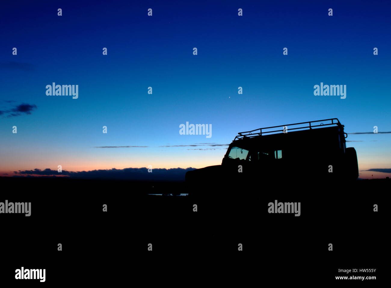 Land Rover defender 110 silhouette on a winter sky sunset Stock Photo