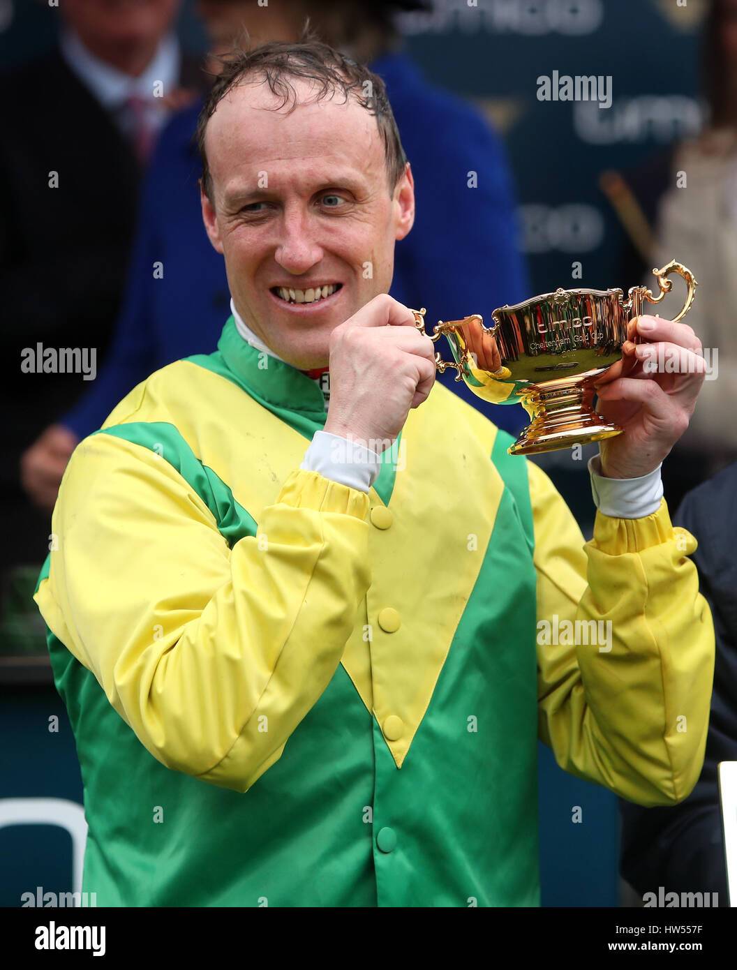 Jockey Robbie Power celebrates with the Timico Gold Cup after his winning ride on Sizing John in the Timico Cheltenham Gold Cup Chase during Gold Cup Day of the 2017 Cheltenham Festival at Cheltenham Racecourse. Stock Photo