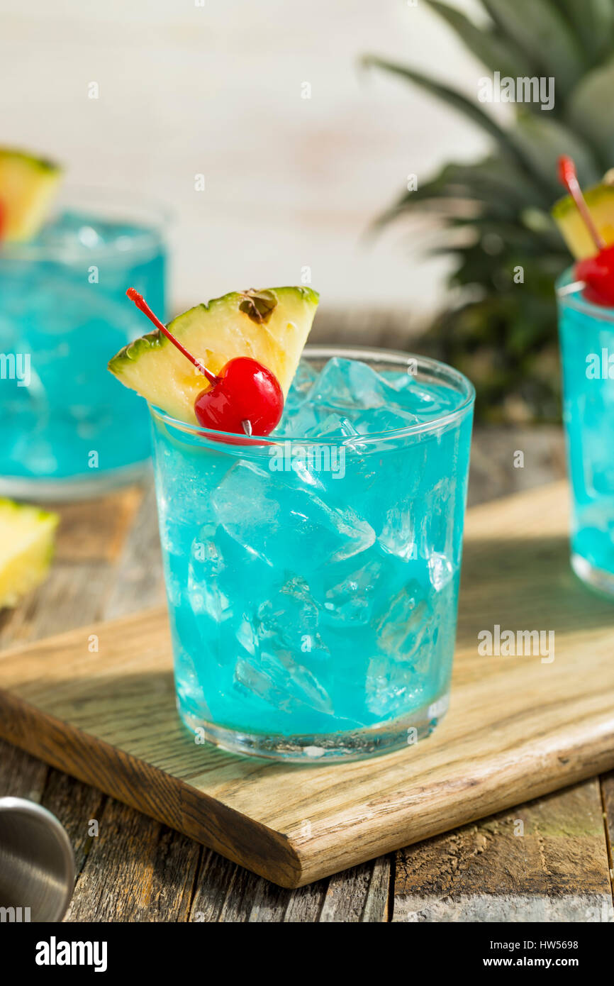 Refreshing Blue Hawaii Cocktail Punch with Pineapple and Cherry Stock Photo