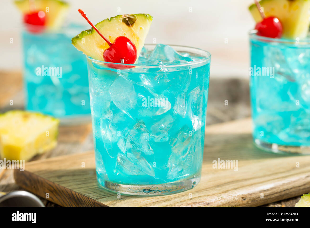Refreshing Blue Hawaii Cocktail Punch with Pineapple and Cherry Stock Photo