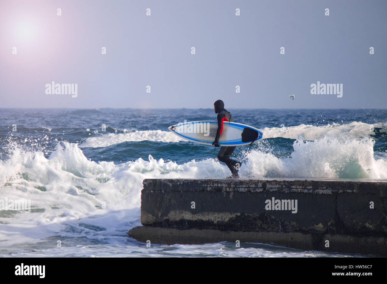 Surfer wearing wetsuit runs ocean hi-res stock photography and images ...