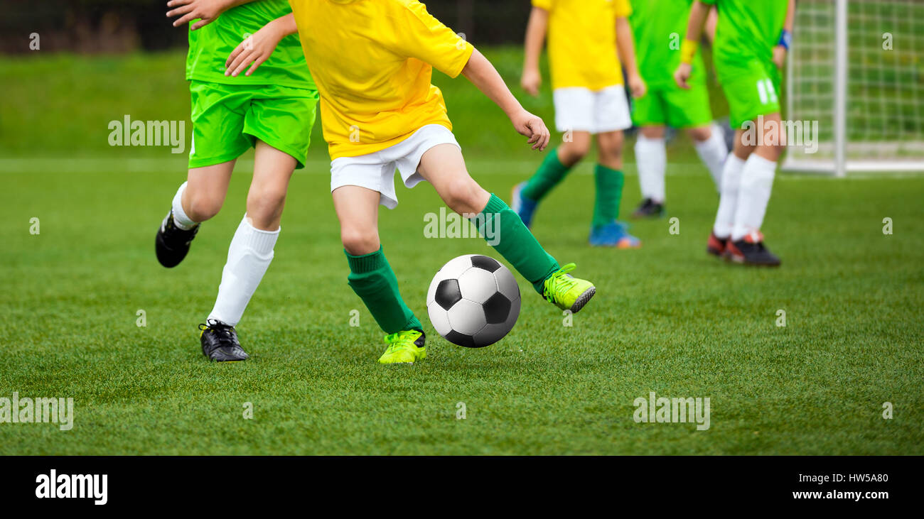Football Player Running with the Ball on the Pitch. Footballers Kicking
