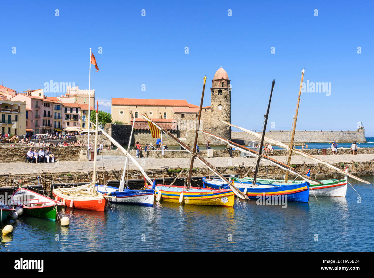 Traditional boats moored at the Port d’Avall with the Church of Notre Dame des Anges behind, Collioure, Côte Vermeille, France Stock Photo