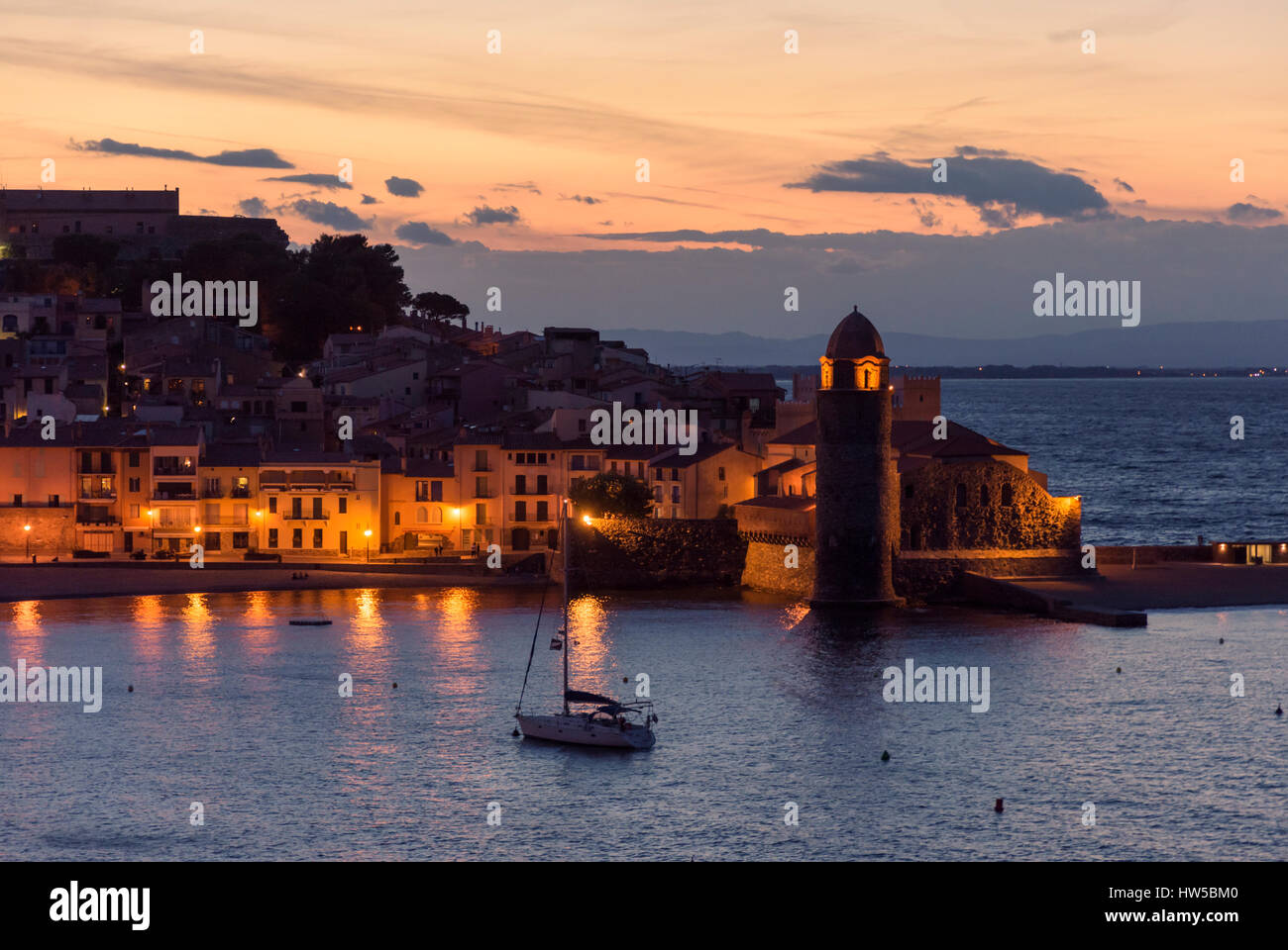 Night view of the town waterfront and bell tower of the Church Notre Dame des Anges, Collioure, Côte Vermeille, France Stock Photo
