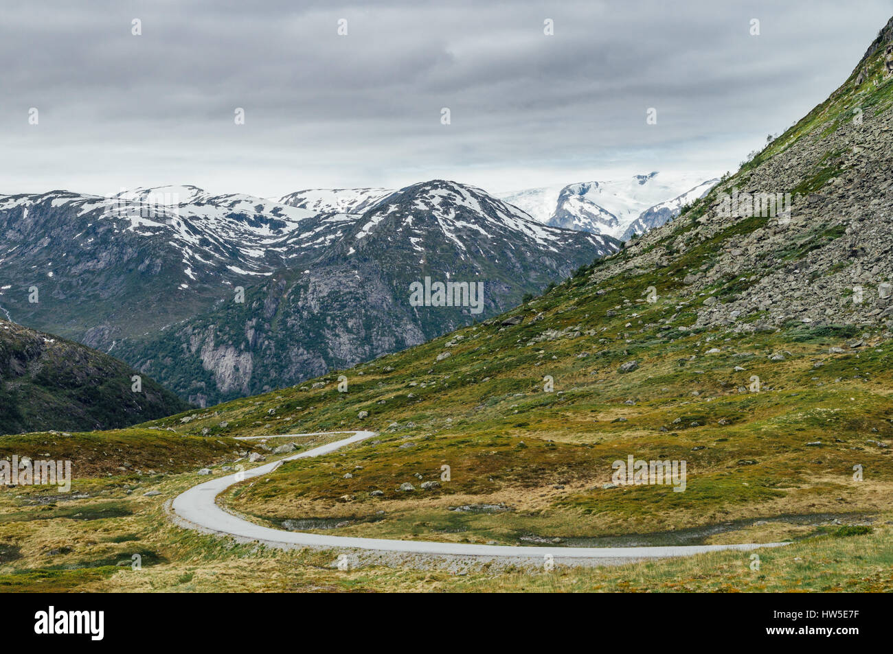 Narrow winding road in mountains, norwegian tundra landscape Stock