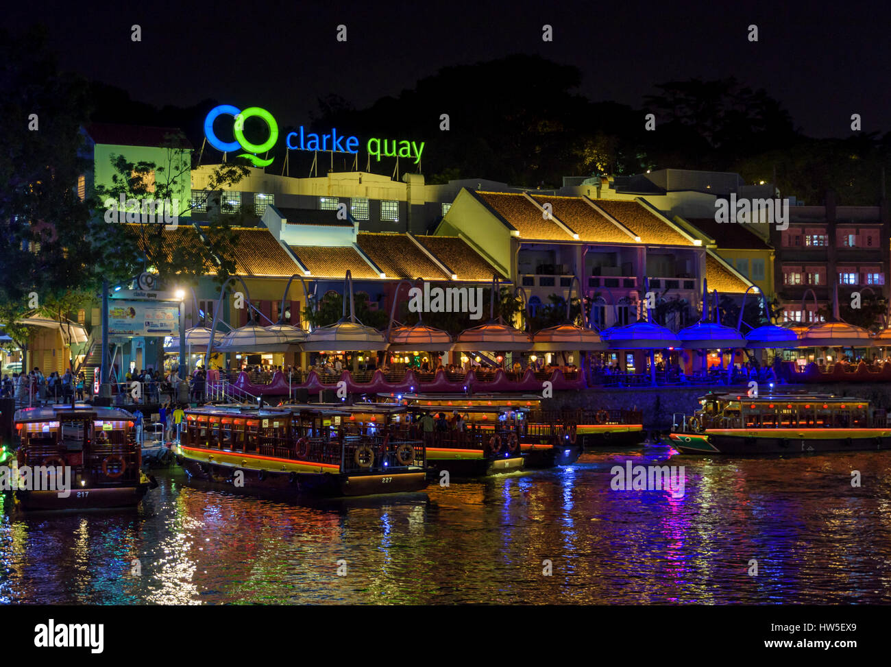 Clarke Quay outdoor precinct at night with busy cafes and restaurants along the riverside, Clarke Quay, Singapore Stock Photo