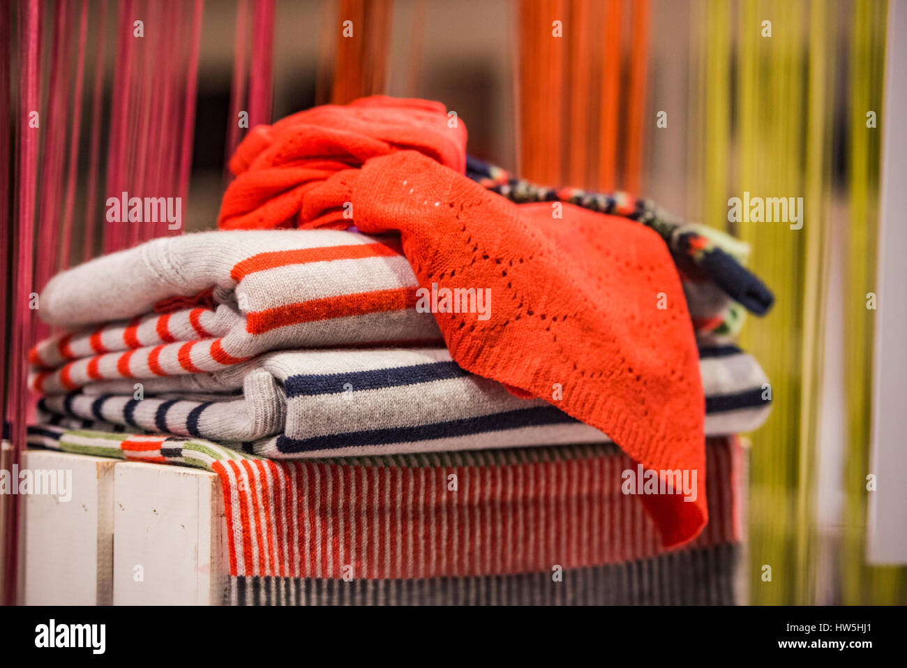 Stacked clothes in a boutique store Stock Photo - Alamy