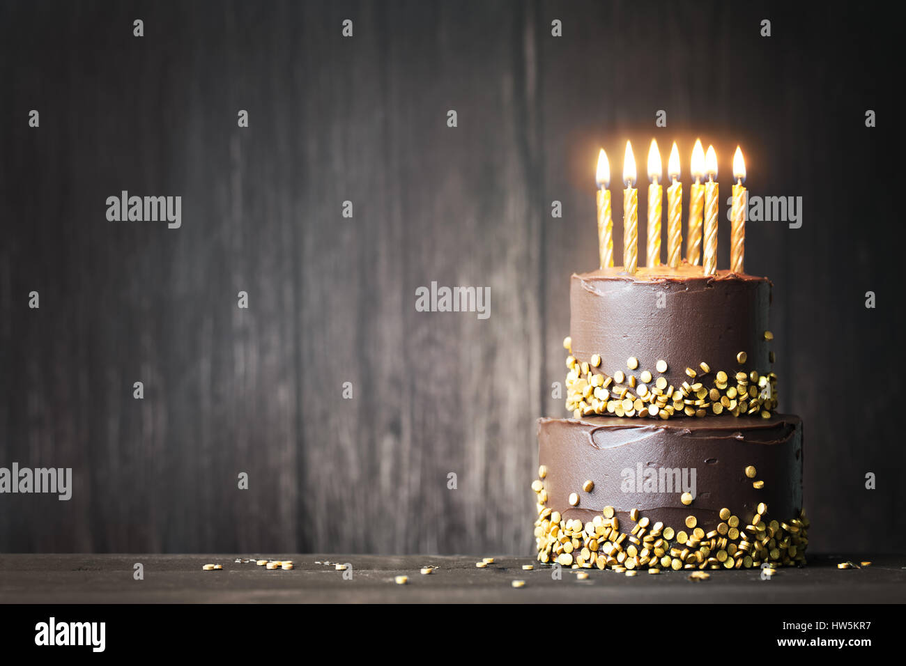Chocolate birthday cake with gold candles Stock Photo - Alamy