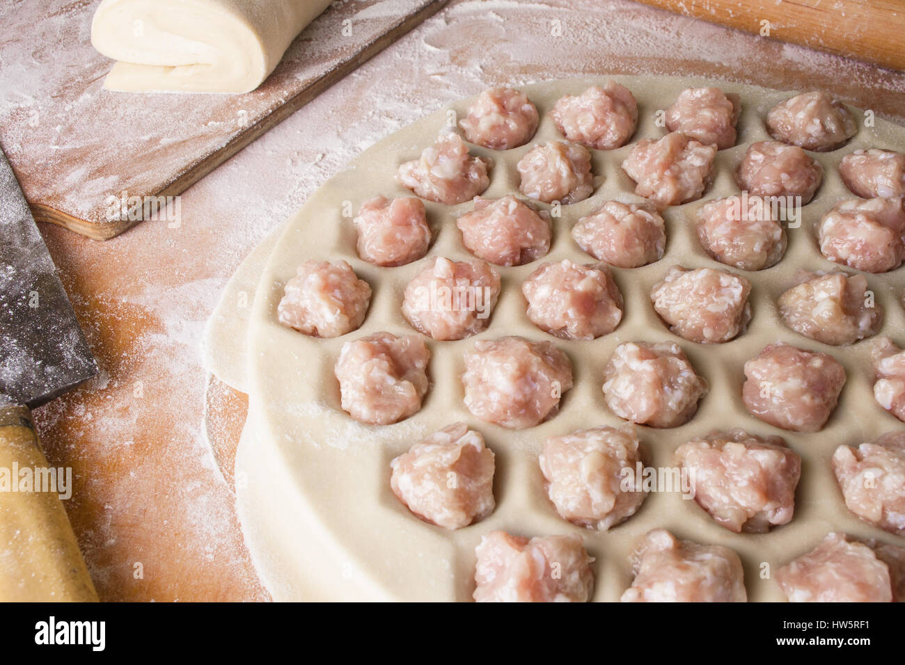 Step by step process of making home-made dumplings, ravioli or pelmeni with minced meat filling using ravioli mold or ravioli maker. Stock Photo
