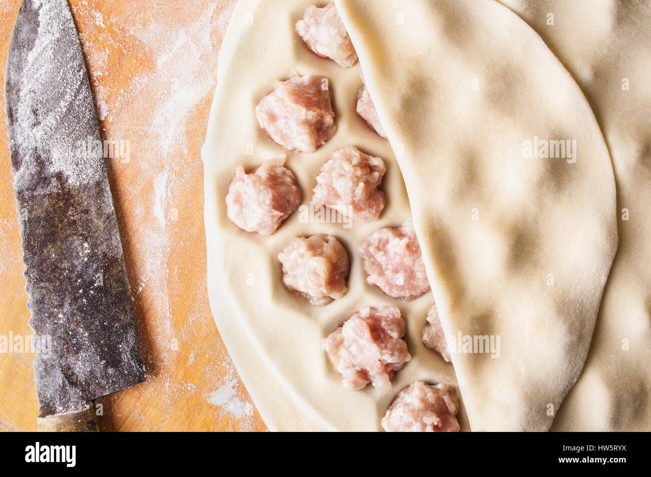 Step by step process of making home-made dumplings, ravioli or pelmeni with minced meat filling using ravioli mold or ravioli maker. Stock Photo