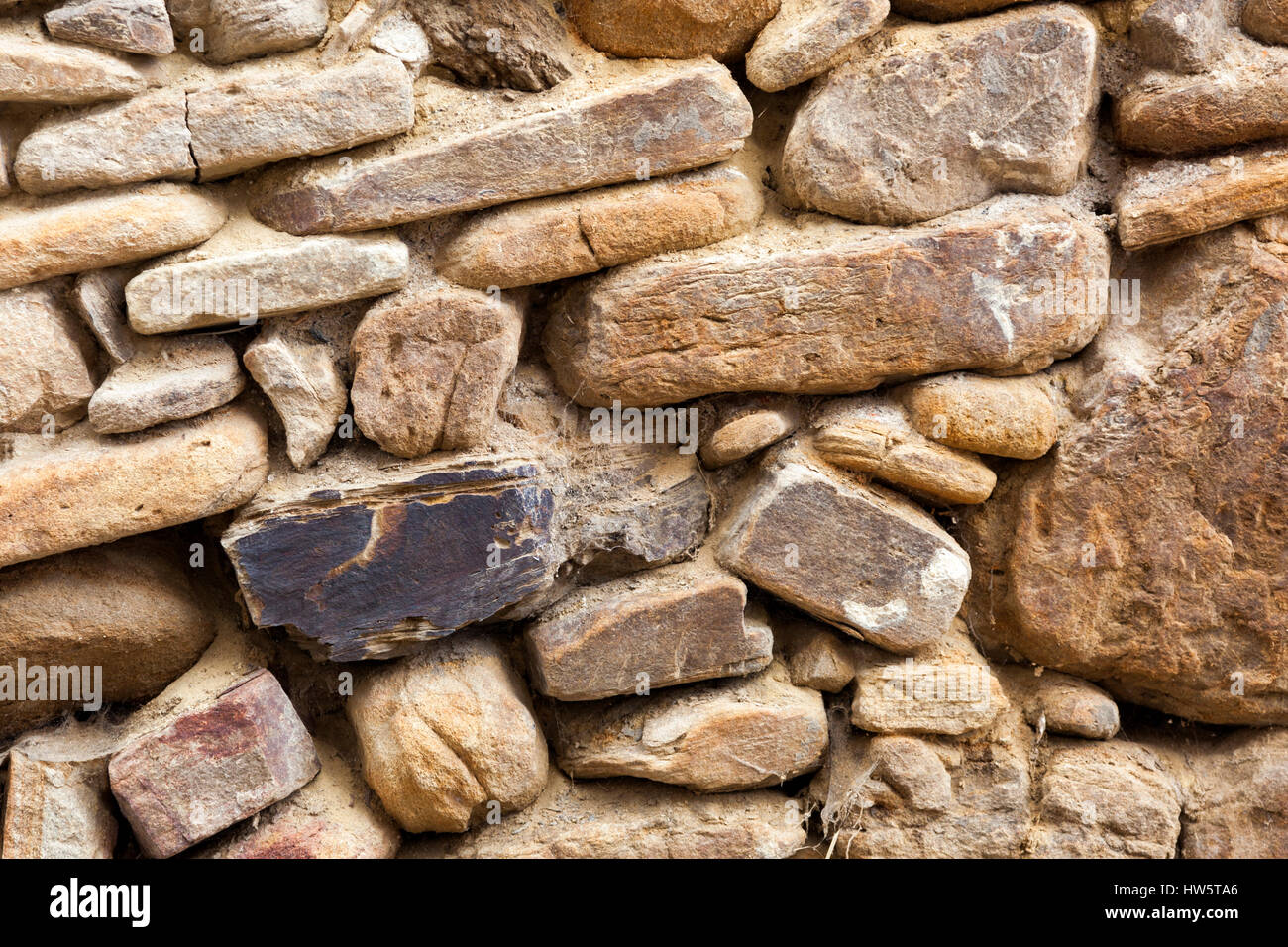Old masonry stone wall from and aged building facade Stock Photo
