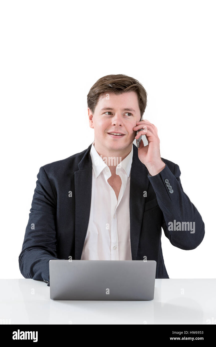 Smiling Businessman Sitting Behind His Desk With Laptop And