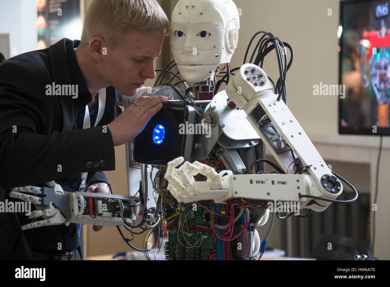 A young scientist testing an anthropoid robot at the Robostation, at Moscow's VDNKh Exhibition Center in Russia Stock Photo