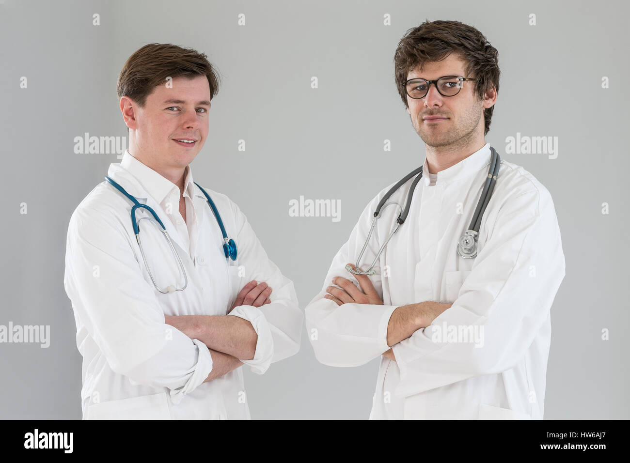 Happy young doctor crossed arms hi-res stock photography and images - Alamy