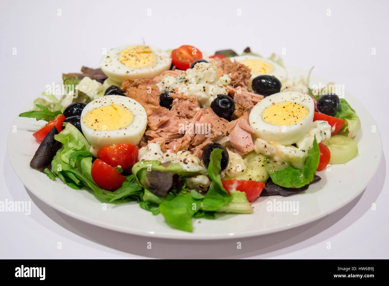 Salad nicoise with tuna olives egg potato tomato and fresh lettuce Stock Photo