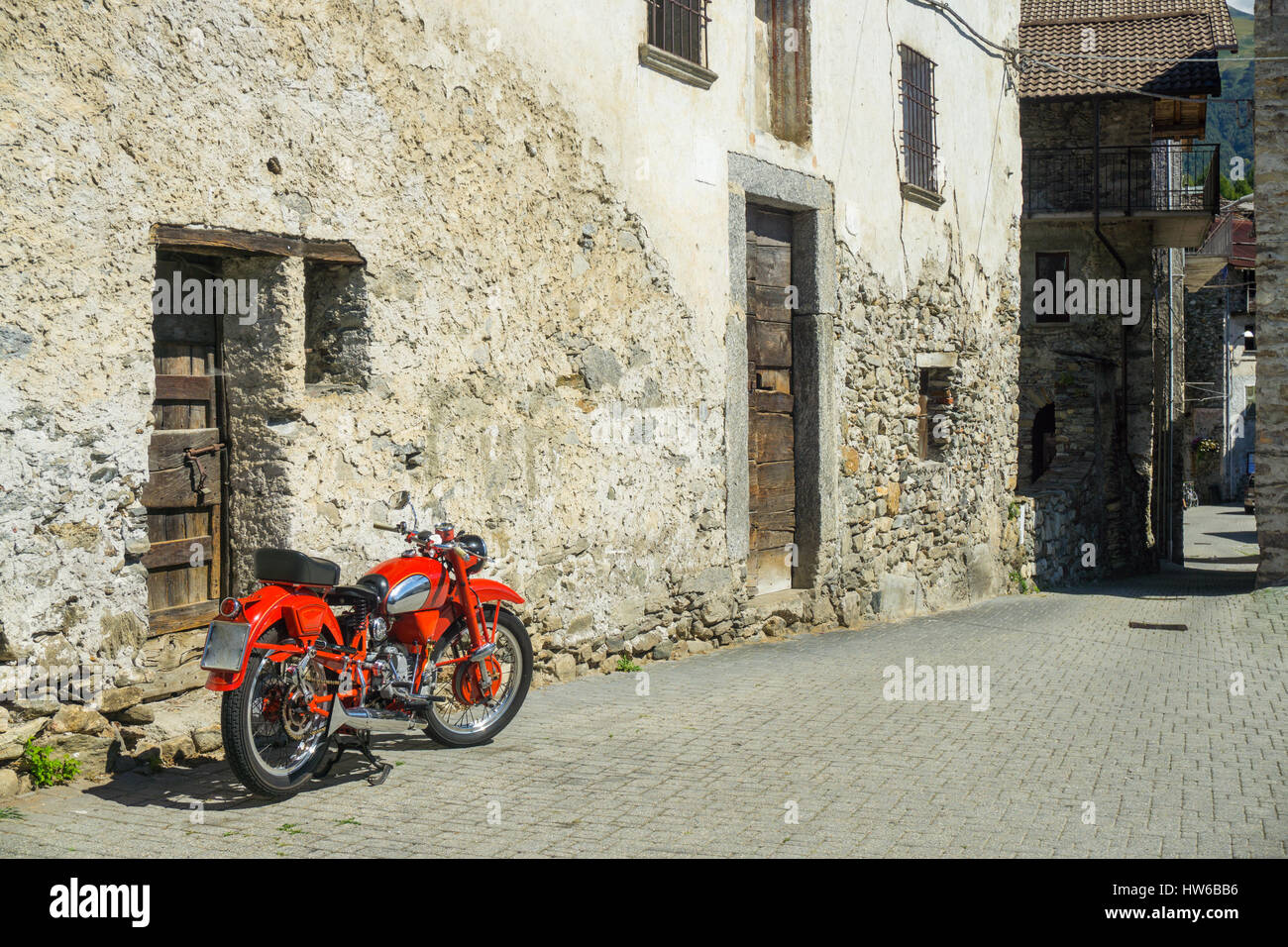 Red bike parked on the street of old town in Italy Stock Photo - Alamy