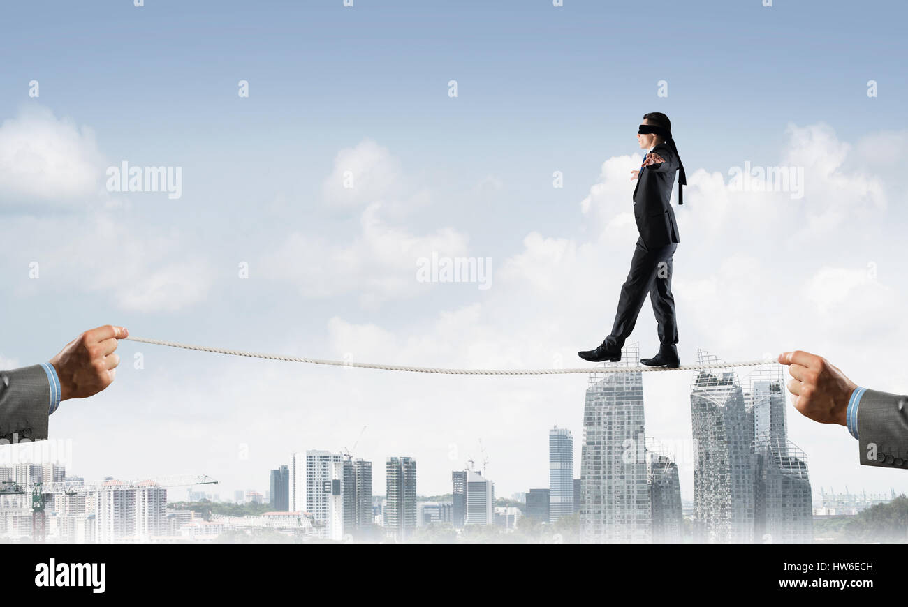 Business concept of risk support and assistance with man balancing on ...