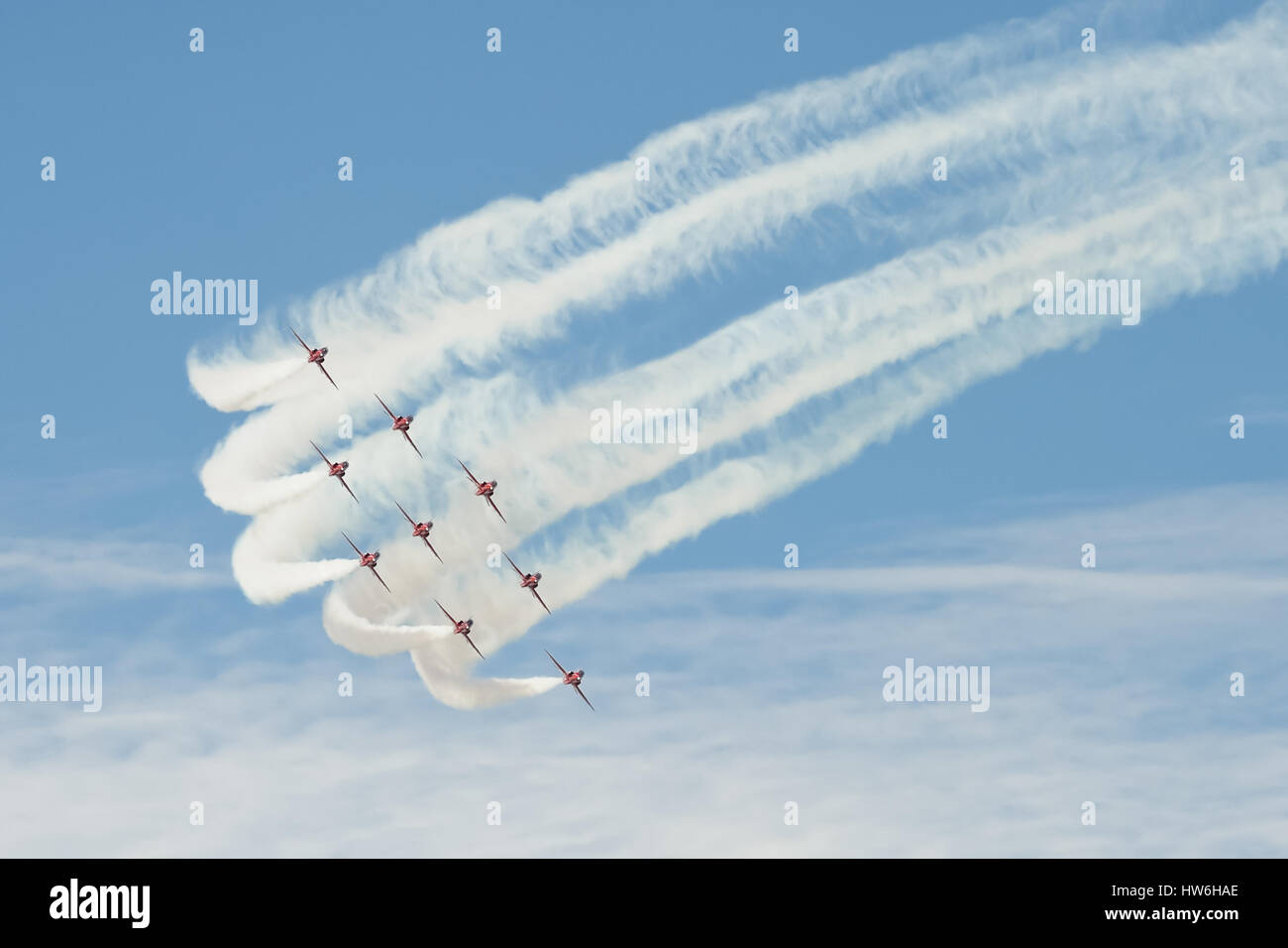 Precision maneuver by the Red Arrows aerobatic display team during the Farnborough Airshow, UK Stock Photo