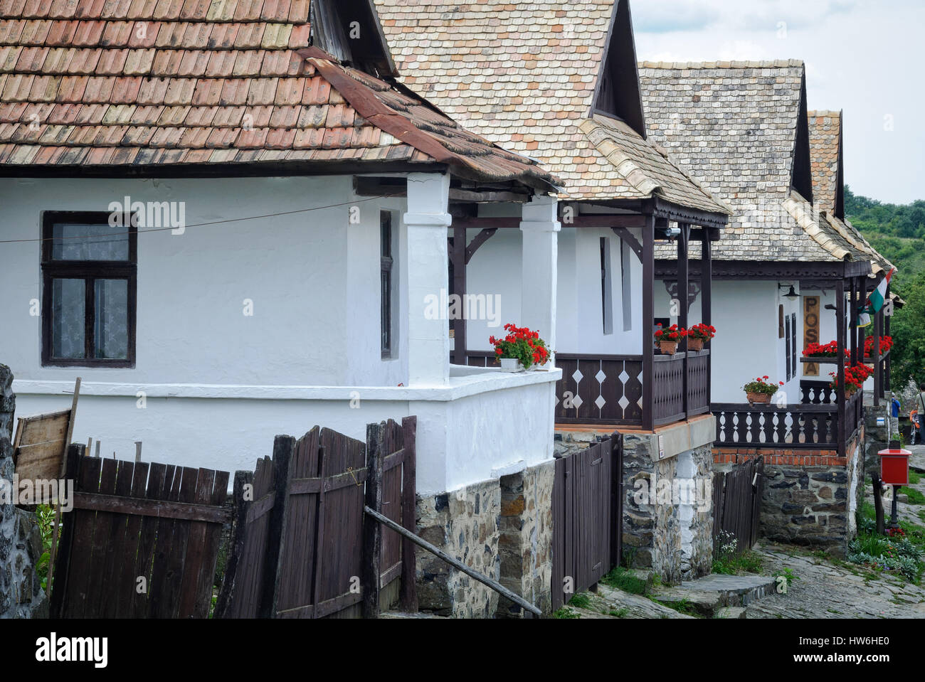 Row of farmhouses with porches decorated with flowers in Holloko, Hungary Stock Photo