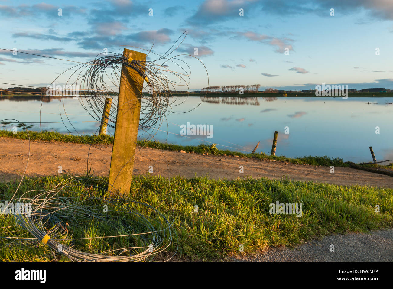Electric fence wire rolled up on a fence post, as the floodway is in
