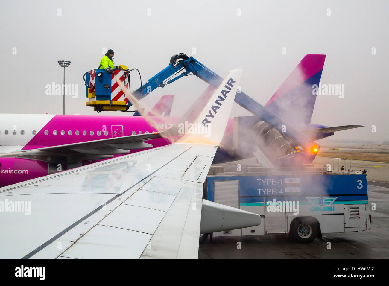 Clearing Ice And De-icing Aircraft. Budapest airport. Hungary, Southeast Europe Stock Photo