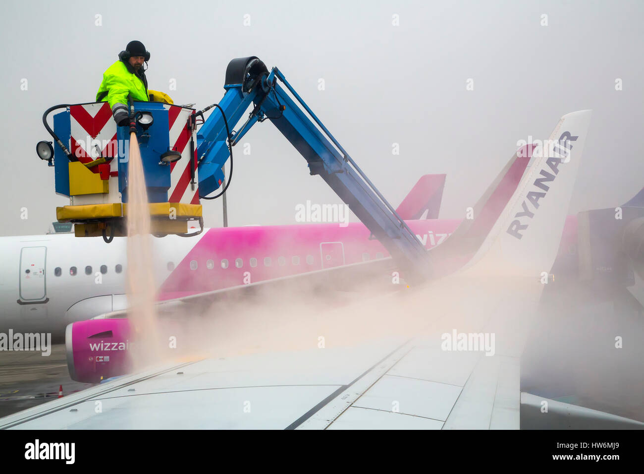 Clearing Ice And De-icing Aircraft. Budapest airport. Hungary, Southeast Europe Stock Photo