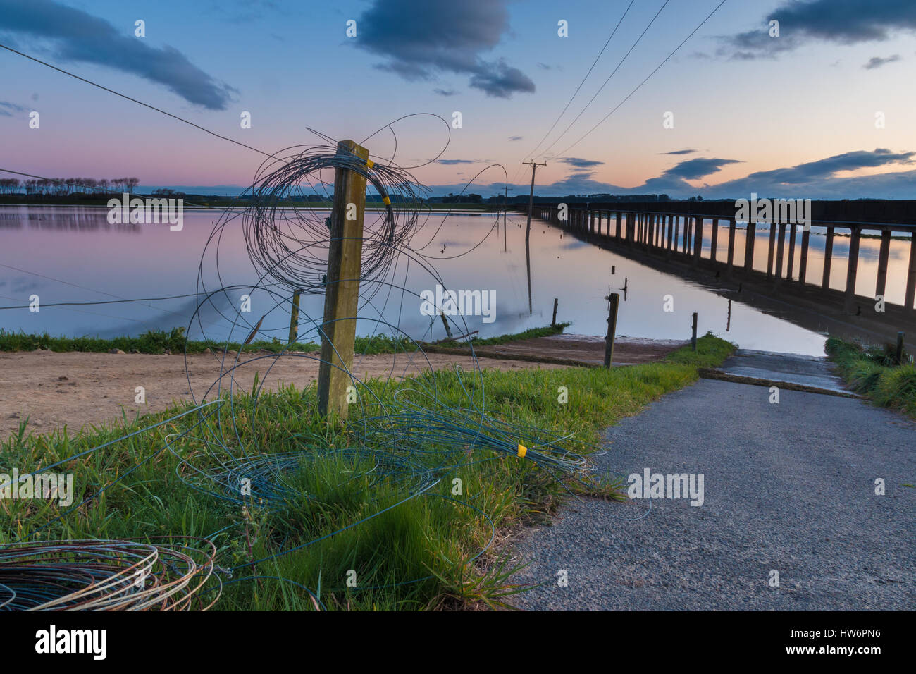 Electric fence wire rolled up on a fence post, as the floodway is in