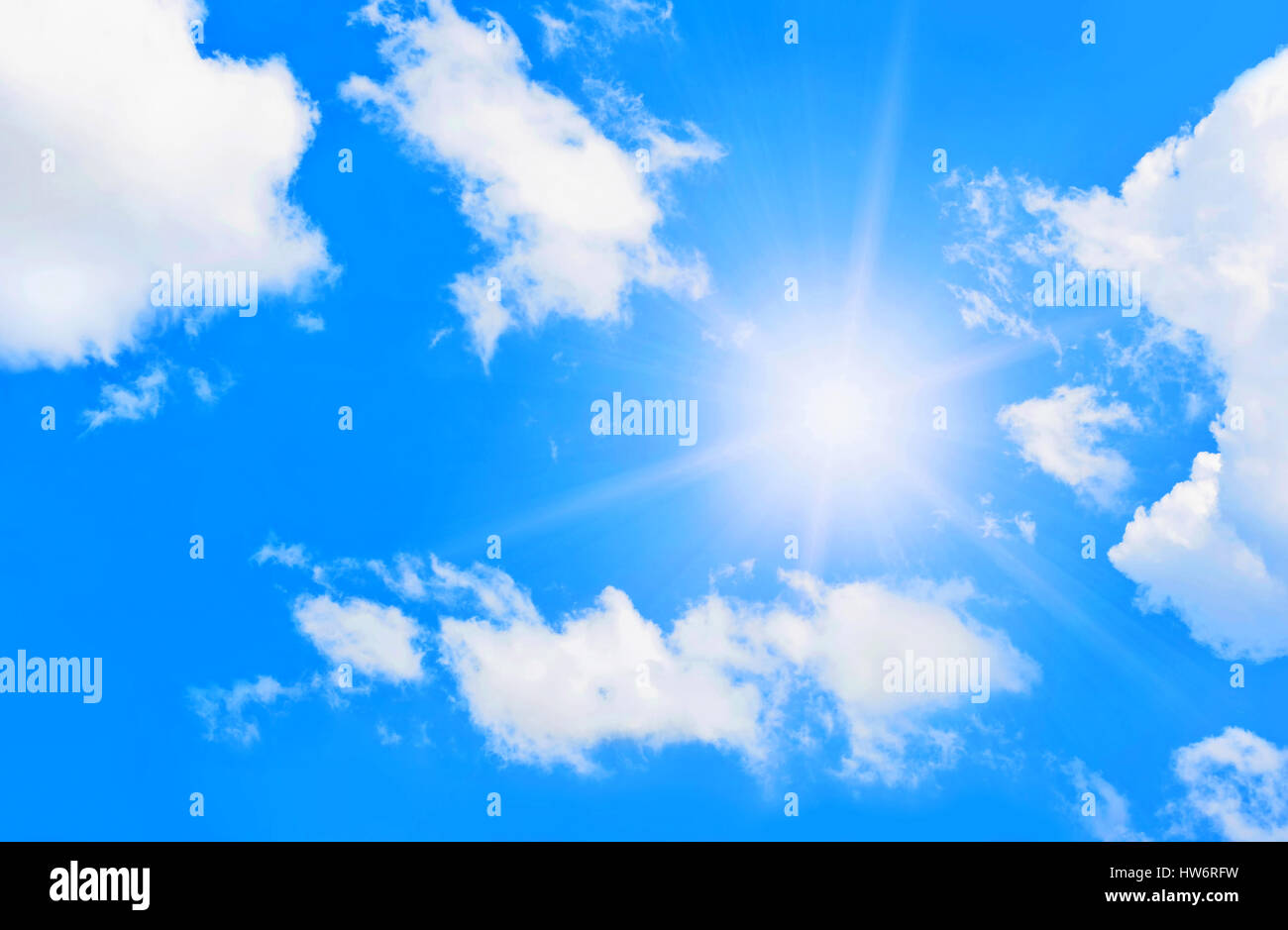 Bright sun in blue sky with clouds Stock Photo - Alamy