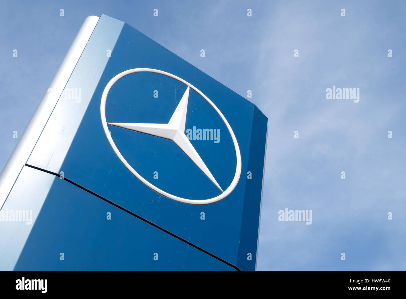 Mercedes-Benz dealership sign against blue sky Stock Photo