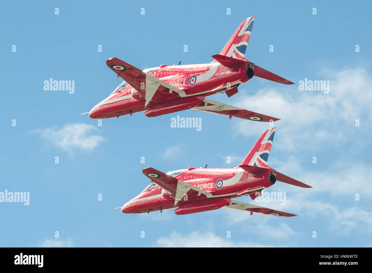 Low-level flypast by the Red Arrows aerobatic display team at an aviation trade event at Farnborough, UK Stock Photo