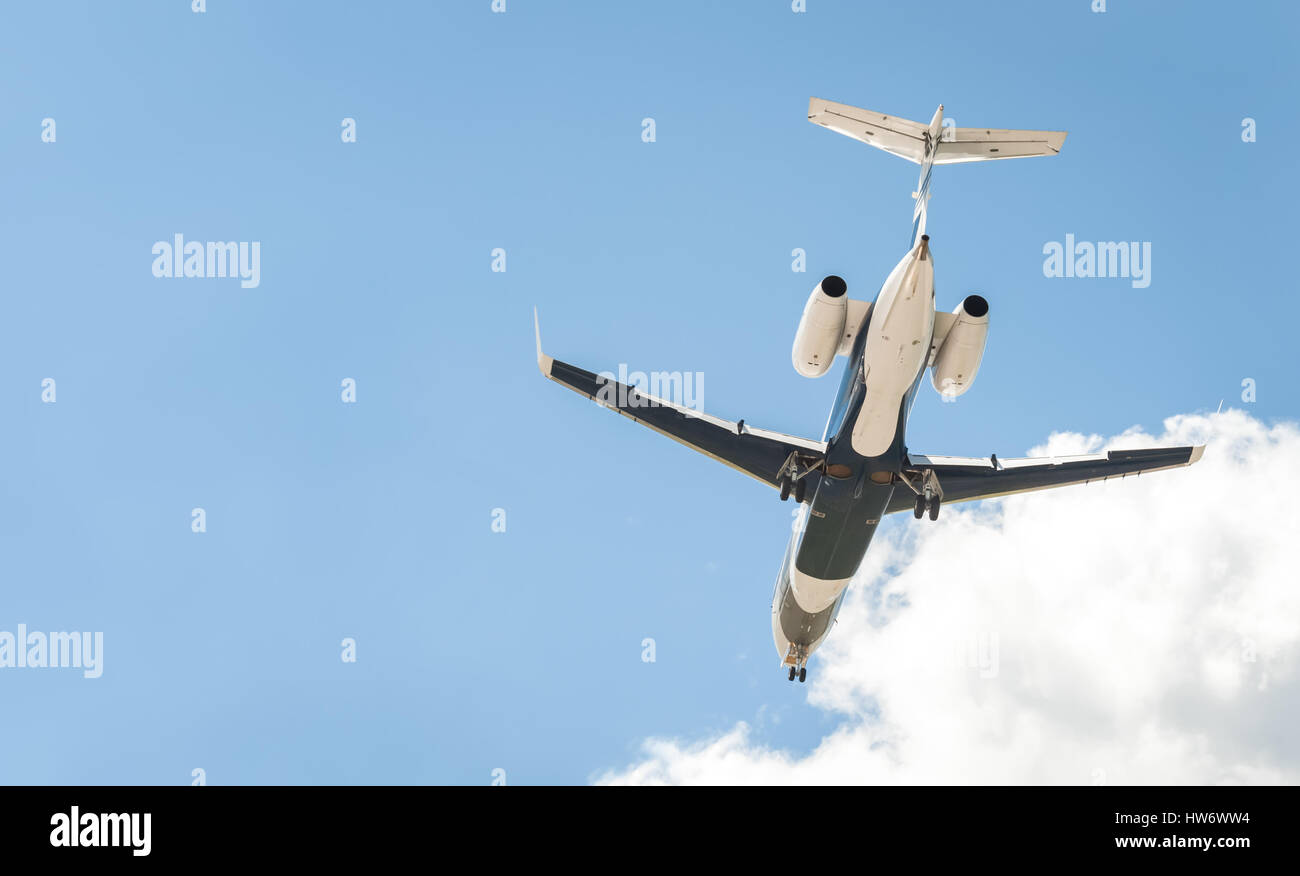 small corporate business jet on landing approach with copy-space Stock Photo