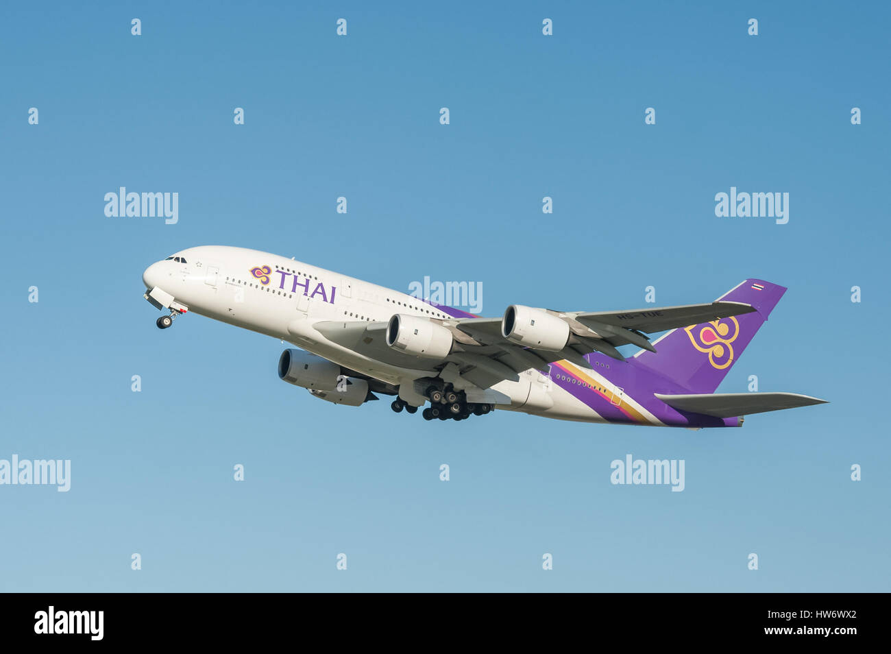 A five hundred seat Thai Airways Airbus A380 departing into a crystal clear blue sky from Heathrow Airport, London, UK Stock Photo