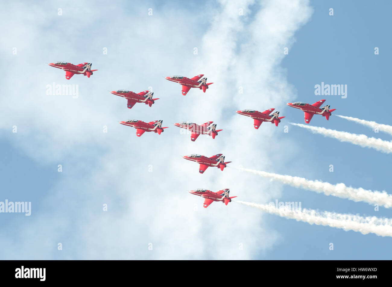 The Red Arrows formation aerobatic display team leaving smoke trails in the sky over Farnborough, UK Stock Photo
