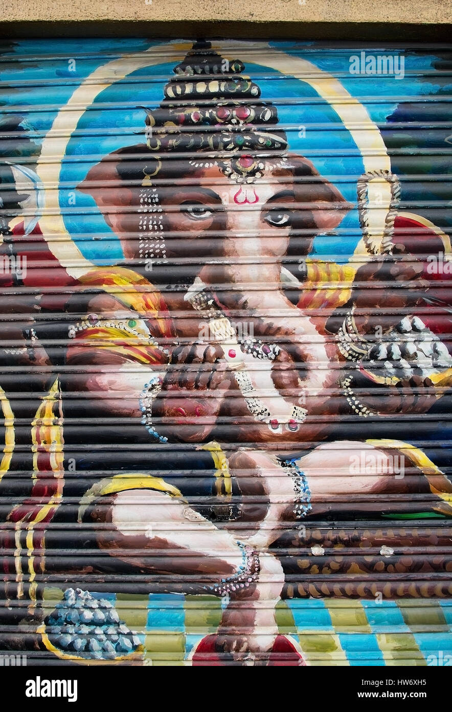 PALMA DE MALLORCA, SPAIN - MARCH 17, 2017: Hindu elephant God Ganesha painting on corrugated metal door Indian restaurant on Calle Sant Magin on a sun Stock Photo