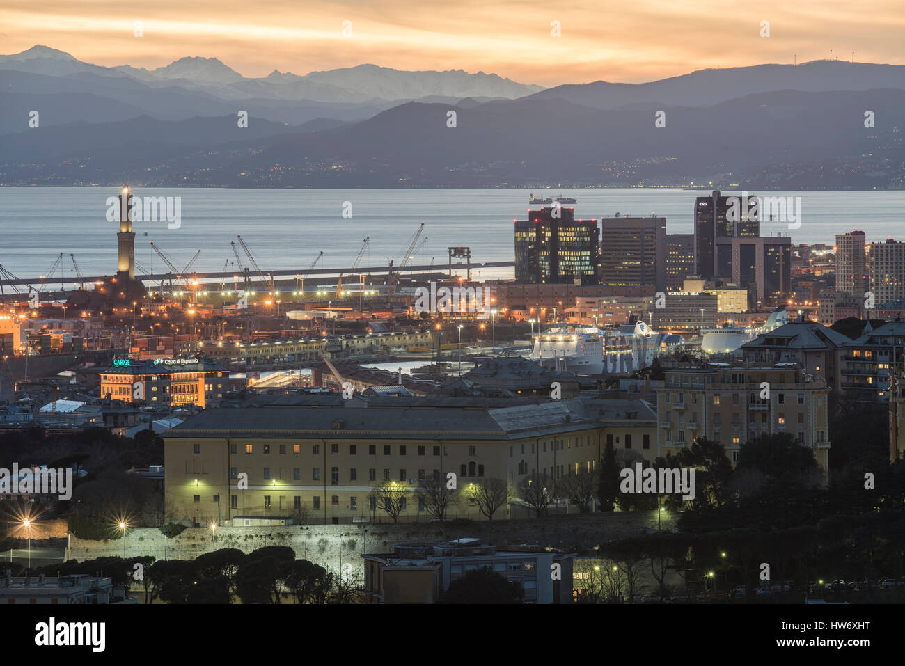 Beautiful viewpoint of city of Genoa, Italy in the sunset with port and ancient lighthouse Stock Photo