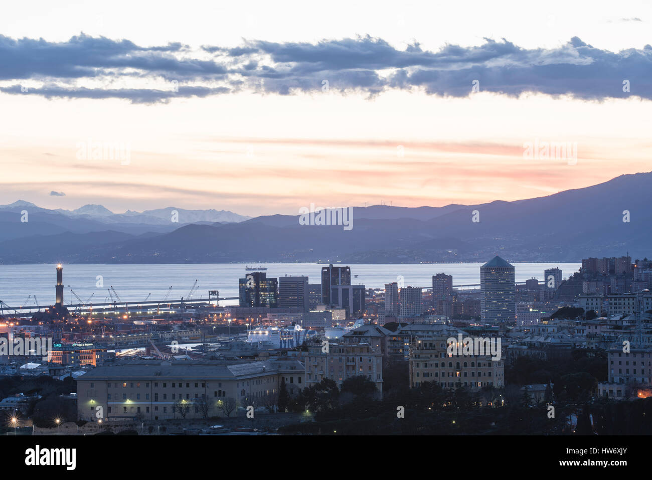 Beautiful viewpoint of city of Genoa, Italy, in the sunset with port and ancient lighthouse Stock Photo