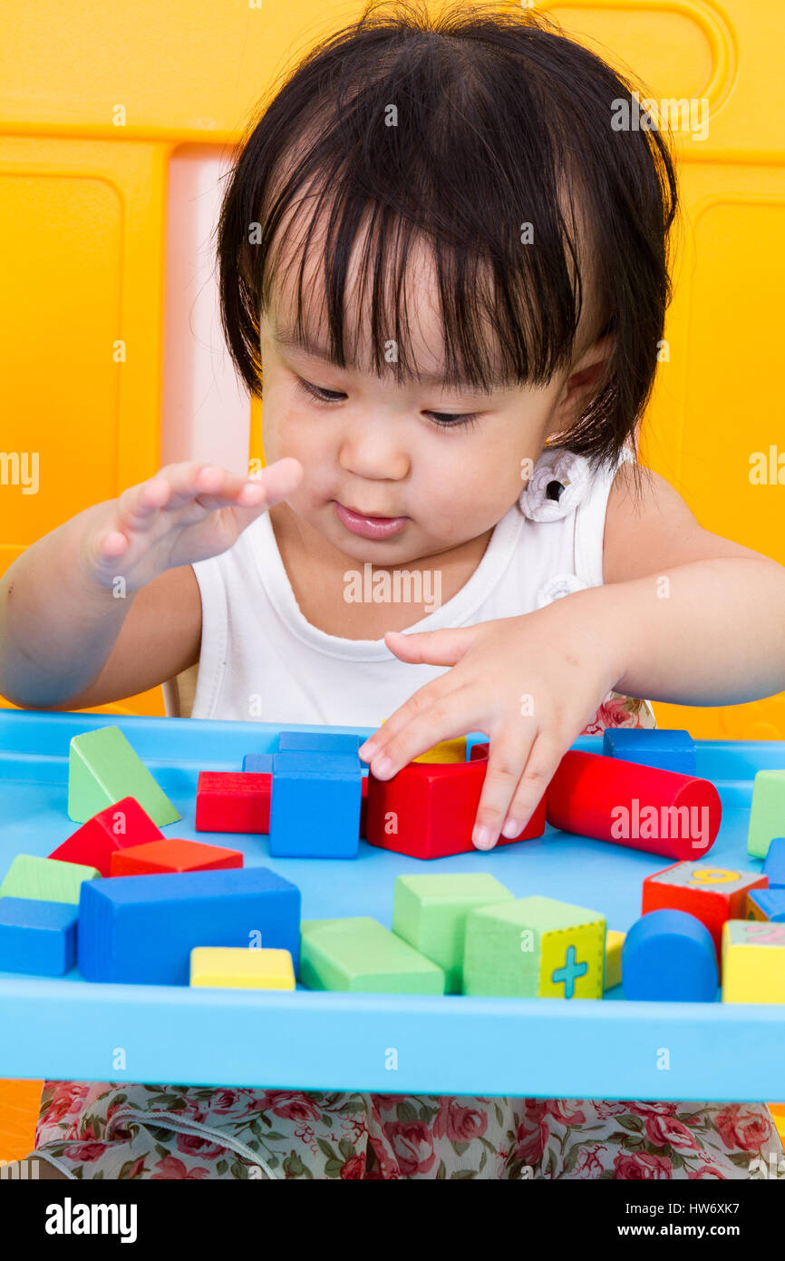 Asian Little Chinese Girl Playing Wooden Blocks at Home or Kindergarten ...