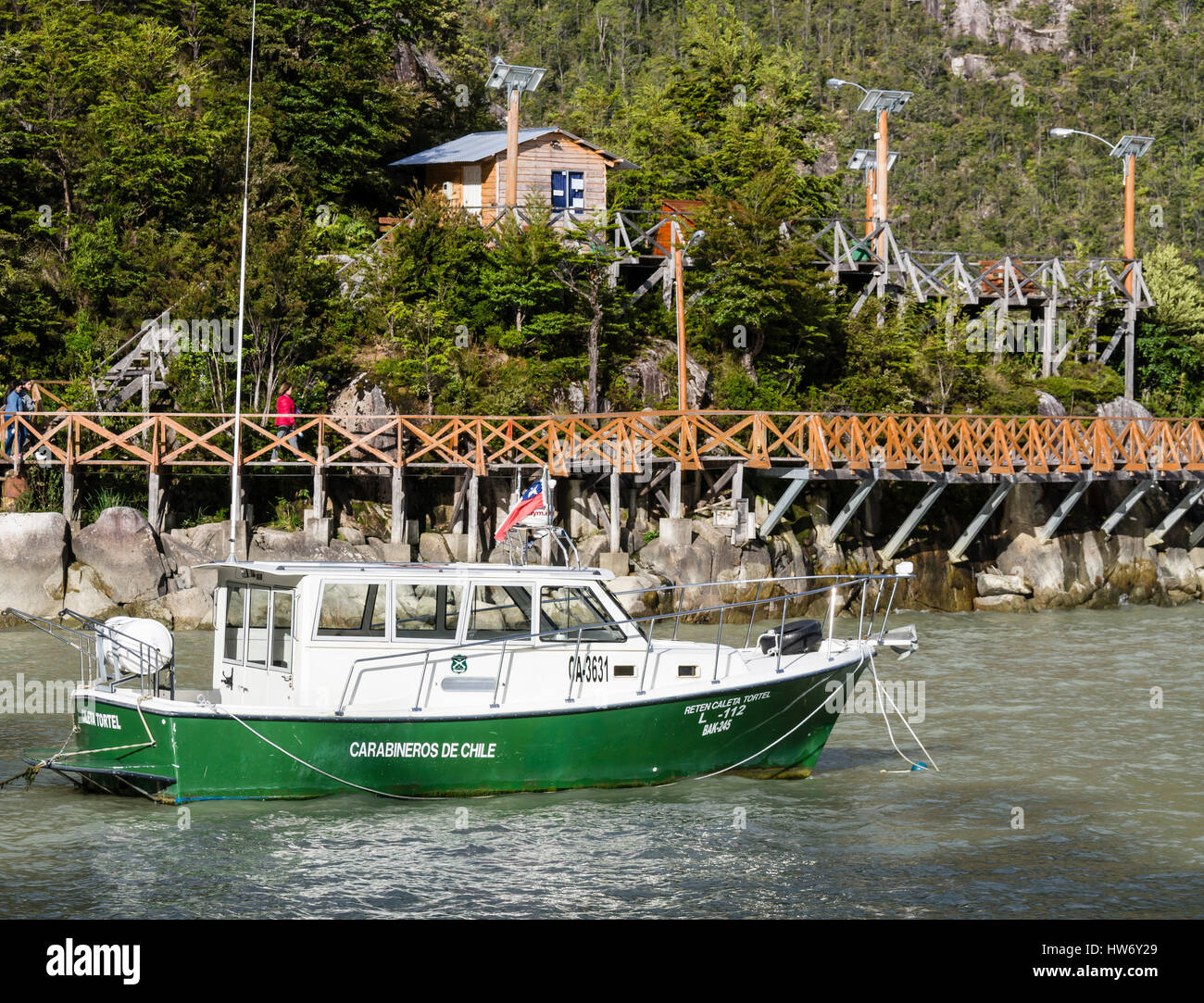 Police boat (carabineros de Chile) anchors in bay of Caleta Tortel, near wooden boardwalk, Caleta Tortel, Aysen region, Patagonia, Chile Stock Photo