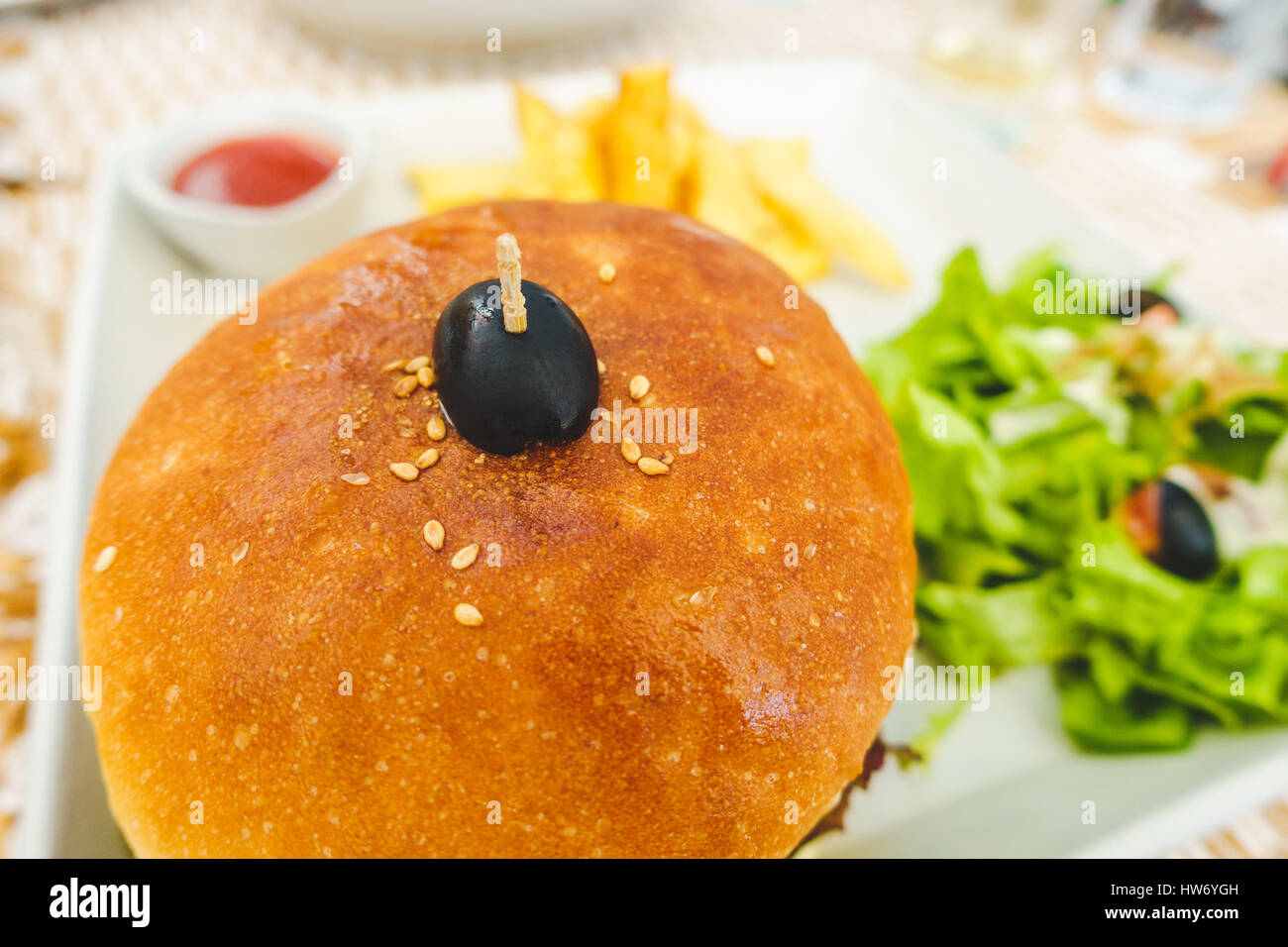 Burger served with salad, chips and tomato ketchup Stock Photo Alamy