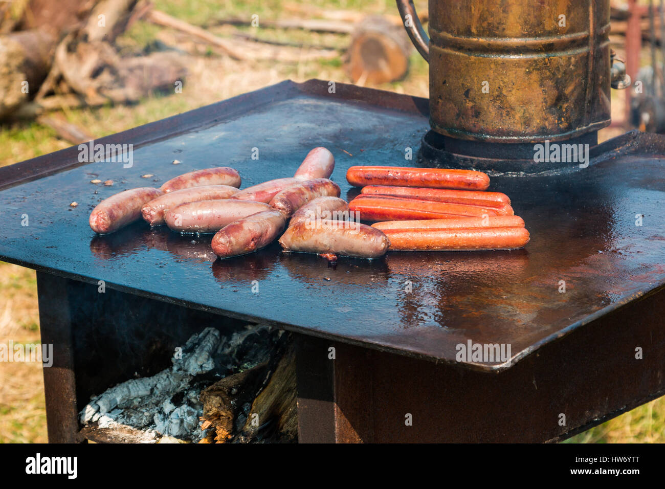 Hot plate BBQ cooker with some sausage cooking Stock Photo Alamy