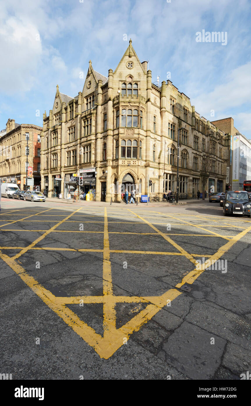 Deansgate a busy road through Manchester city centre lined with shops